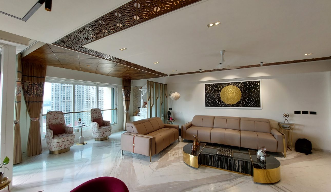 A luxurious 3BHK residence with Parisian-inspired interiors, featuring ornate moldings, a chandelier, velvet seating, and gold-accented decor.
