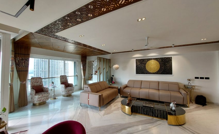 A luxurious 3BHK residence with Parisian-inspired interiors, featuring ornate moldings, a chandelier, velvet seating, and gold-accented decor.
