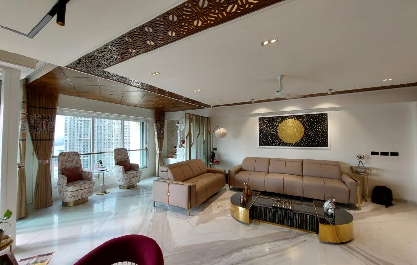 A luxurious 3BHK residence with Parisian-inspired interiors, featuring ornate moldings, a chandelier, velvet seating, and gold-accented decor.