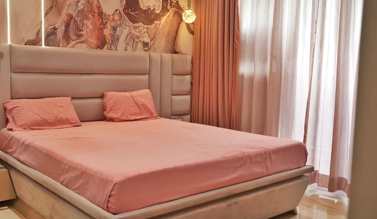Luxurious bedroom with an Arabic-inspired headboard, soft lighting, and elegant European furnishings at Imperial Heights 3BHK, Goregaon.
