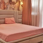 Luxurious bedroom with an Arabic-inspired headboard, soft lighting, and elegant European furnishings at Imperial Heights 3BHK, Goregaon.