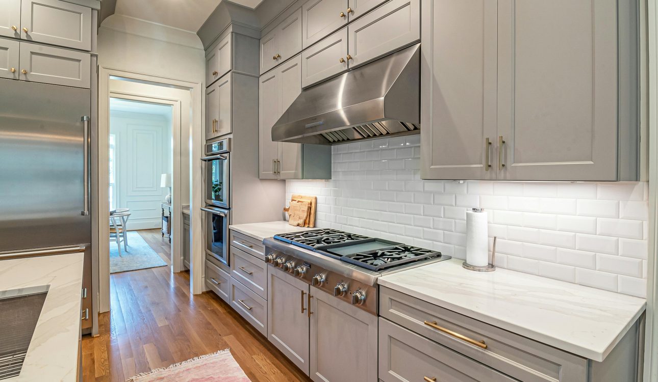 Modern 4BHK luxury kitchen design featuring marble island, smart appliances, and ambient lighting for 2025 homes.