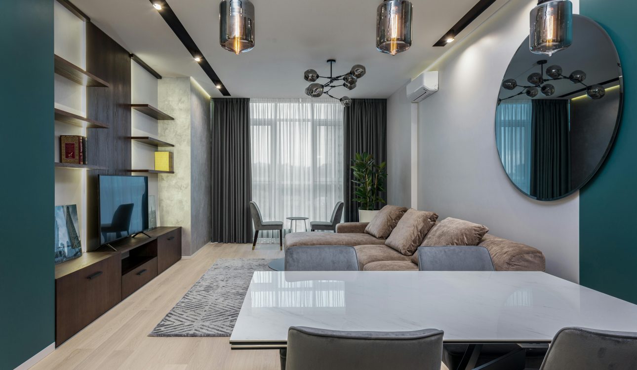 Luxurious 4BHK living room with chandelier, marble floor, and plush sofas