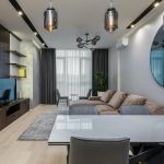 Luxurious 4BHK living room with chandelier, marble floor, and plush sofas