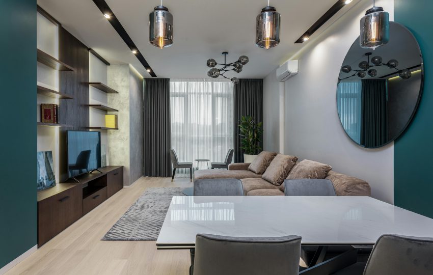 Luxurious 4BHK living room with chandelier, marble floor, and plush sofas
