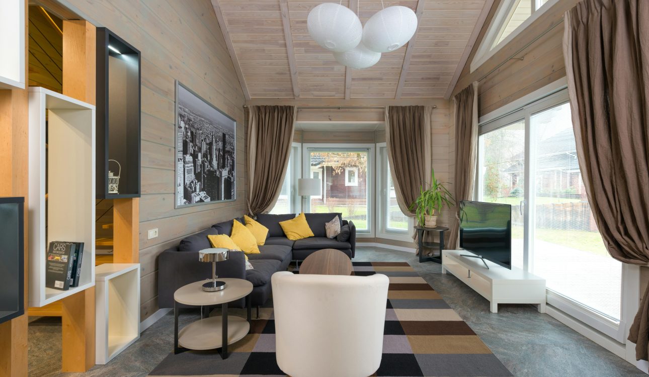 Luxurious living room interior with beige sofas, modern lighting, and marble walls in a 4BHK Mumbai flat.