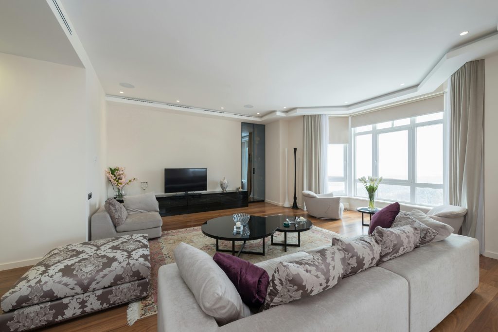 residential interior design, living room with elegant sofa, warm lighting, and decorative accents.